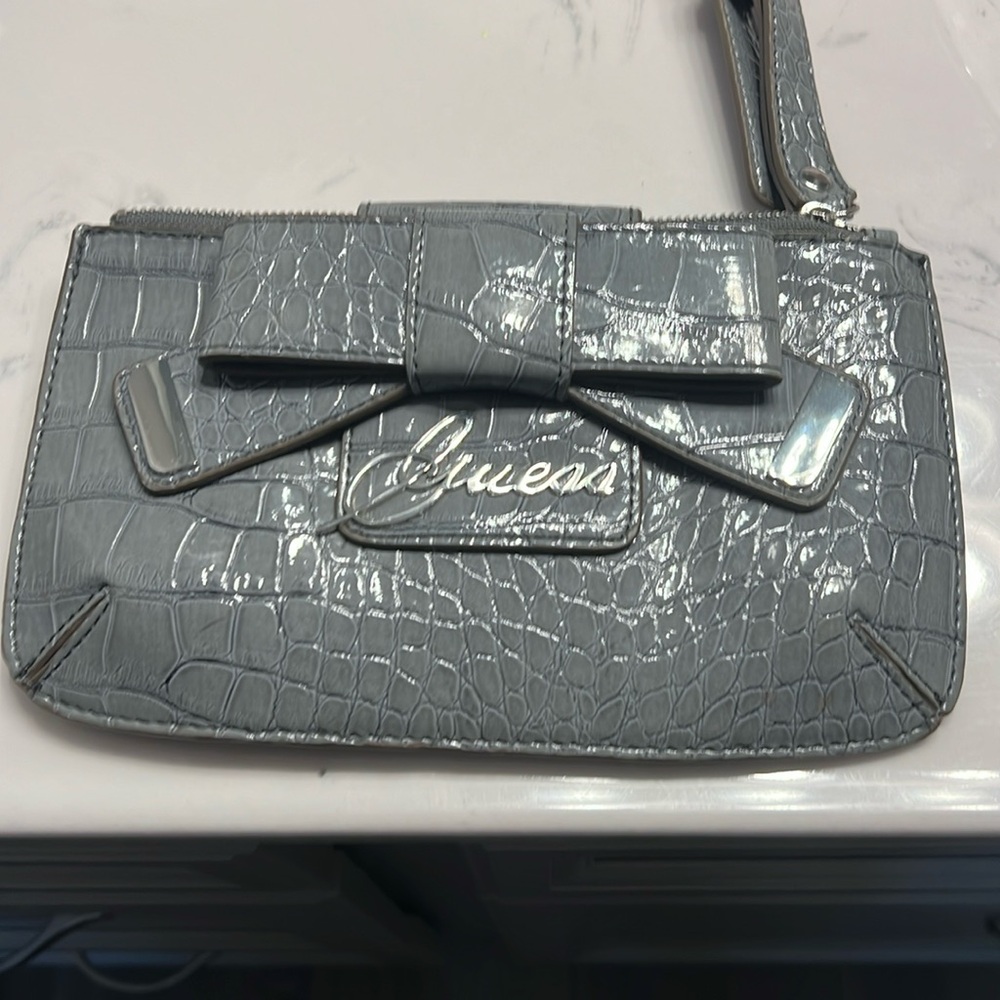Womens grey guess wristlet excellent condition. Strap is adjustable